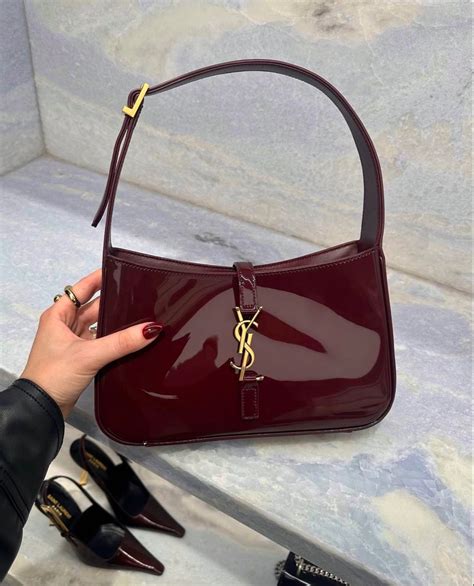 New cherry red patent YSL Yves Saint Laurent bag .